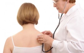 Medical doctor examining female patient.