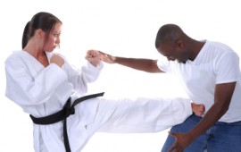 Women's self defence; a young lady defends her self in a practice class.
