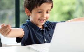 Little boy connecting with his Mom on computer.