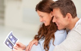 Excited parents-to-be, looking at their sonogram.