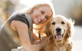 Smiling blonde female and her dog.