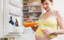 pregnant woman with glass of orange juice