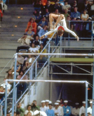 Olympic Medal winning Gymnast Olga Korbut perfoming a bar flip.