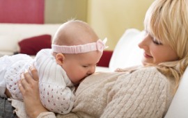 Mother breastfeeding her baby girl