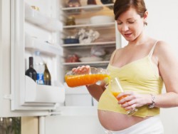 pregnant woman with glass of orange juice